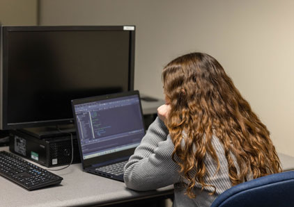 Student at computer.