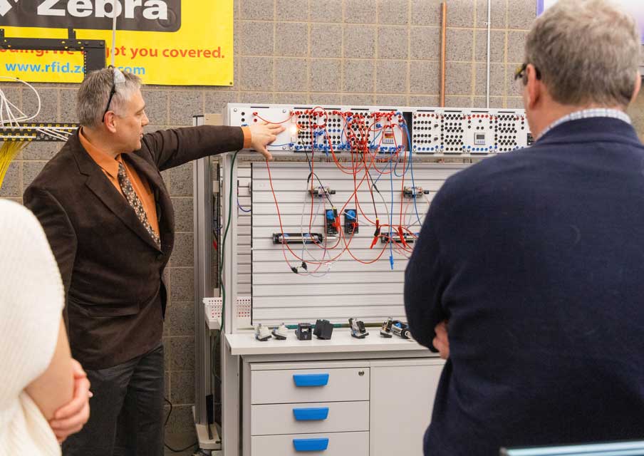 Boguslaw Zappal, faculty CAD and Manufacturing coordinator, demonstrates a pneumatic trainer during the Spotlight On: Manufacturing event at Oakton College April 10. 